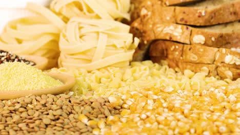 a variety of grains and sliced bread arranged in a well-lit setting, highlighting textures and colors