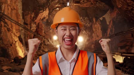 woman miner celebrating success in a mine tunnel