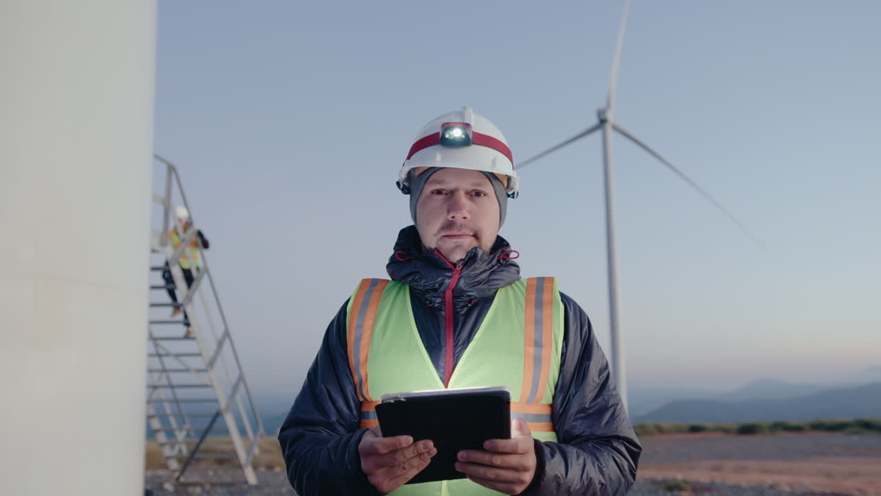 Renewable Energy Engineer Posing with Digital Tablet on Wind Farm