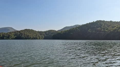 a tranquil lake scene with a kayak moving across