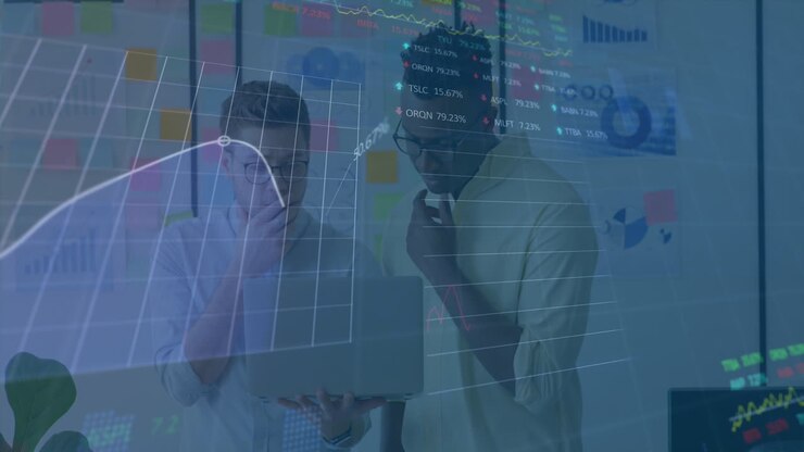 Animation of stock market data processing against two diverse men discussing over a laptop at office