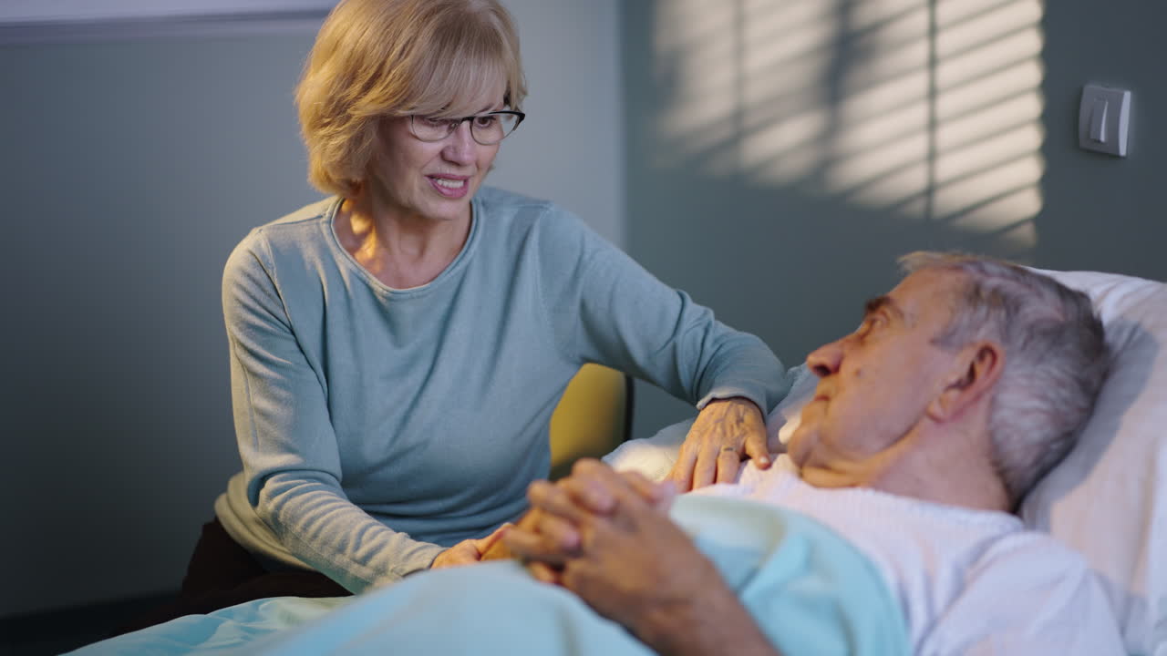 Elderly patient with support in hospital bed