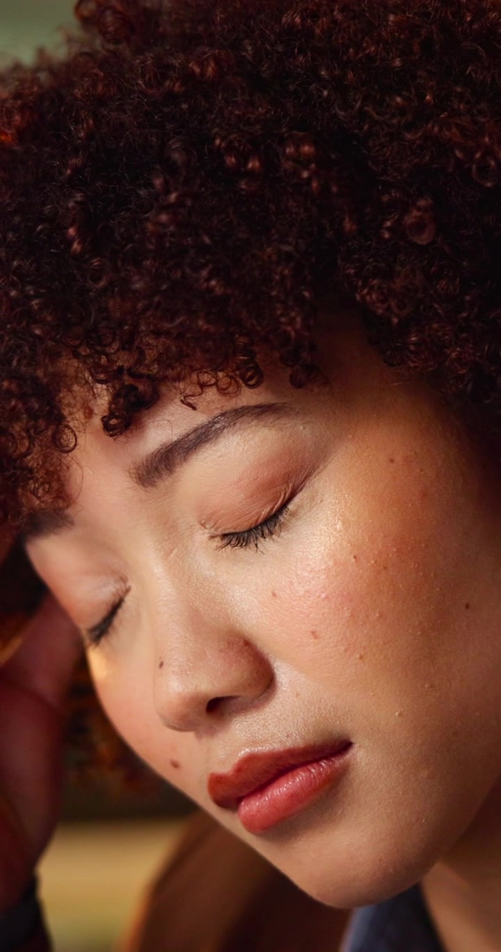 Close-up Portrait of a Young Woman Experiencing a Headache