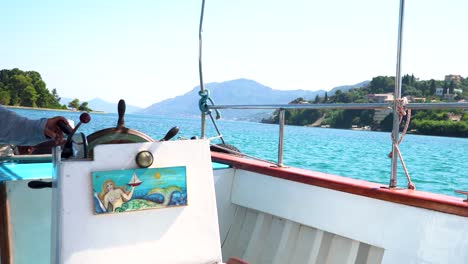 crew member of the boat steering the helm to the left