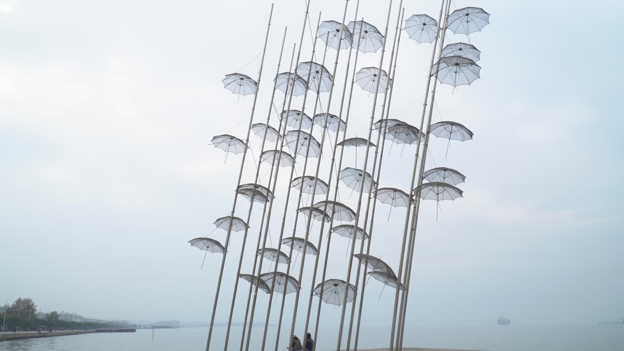 Couples sitting under umbrellas in Thessaloniki. Travel destination in Thessaloniki