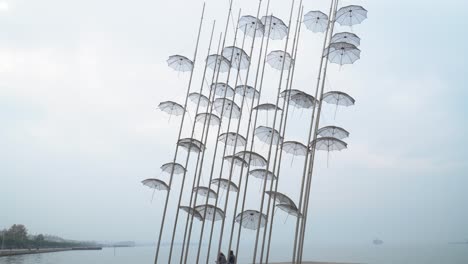 couples sitting under umbrellas in thessaloniki. travel destination in thessaloniki