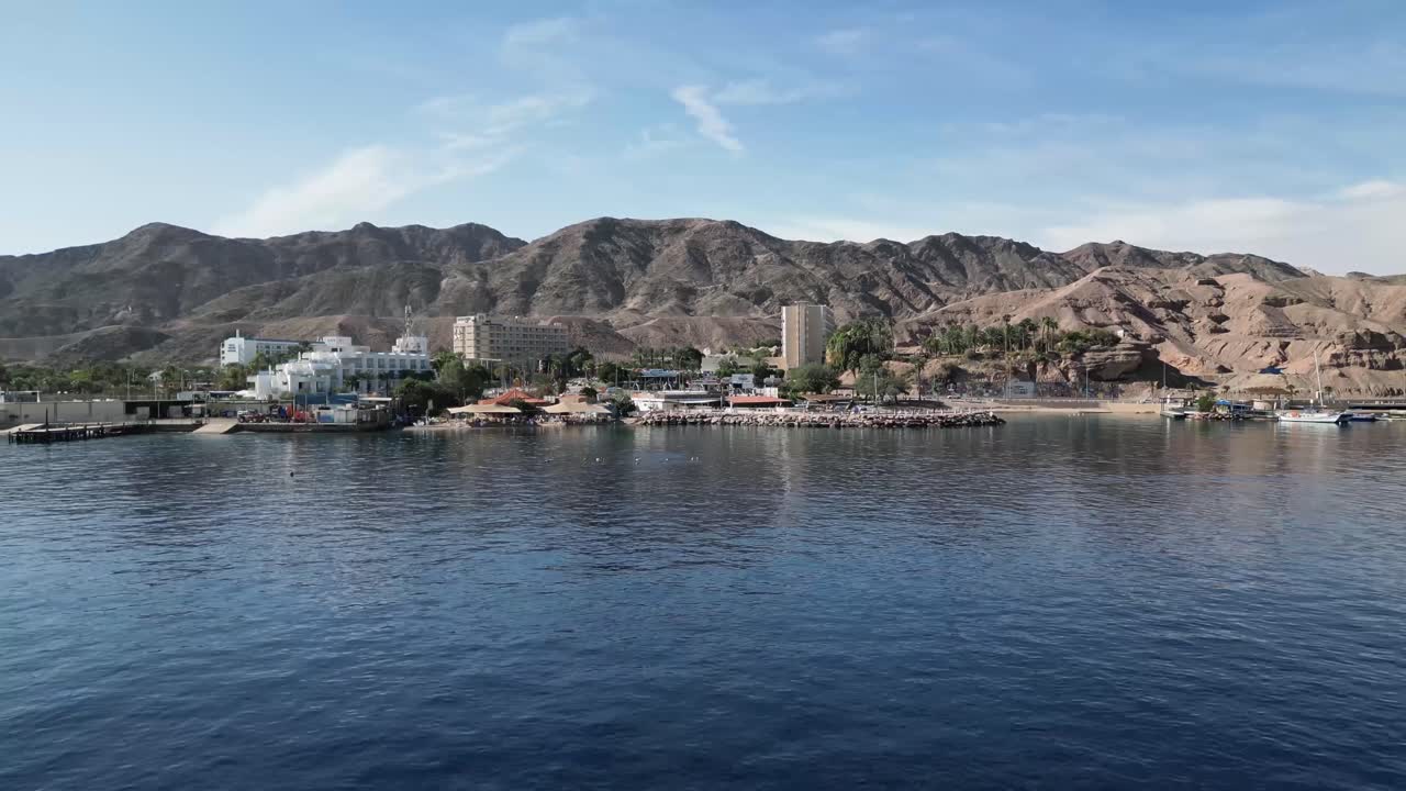 A view of a beach in a coastal desert city captured by a drone