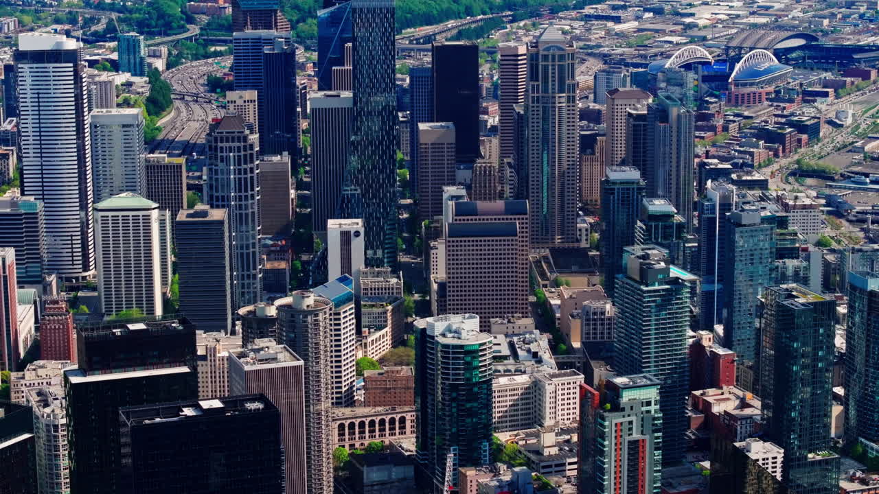 Aerial drone view of downtown Seattle, Washington, showcasing skyscrapers, urban streets, and the city’s modern skyline from above. Ideal for travel, cityscape, and urban environment footage