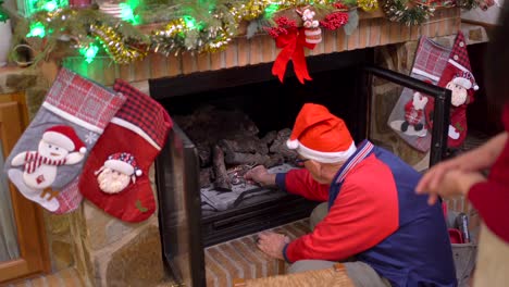 man lighting fireplace on christmas day