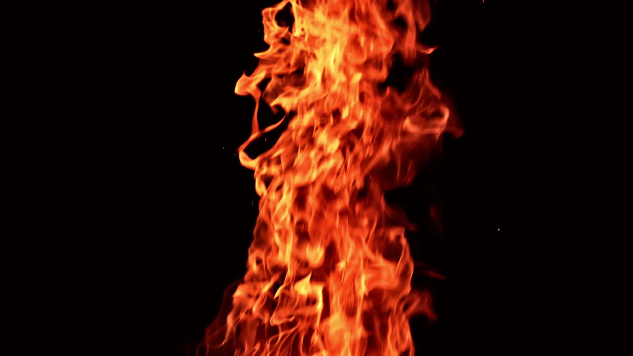 Hot dangerous fire burning at night. Close look at the campfire isolated at black background.