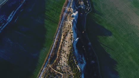 aerial view of a field and rock formation