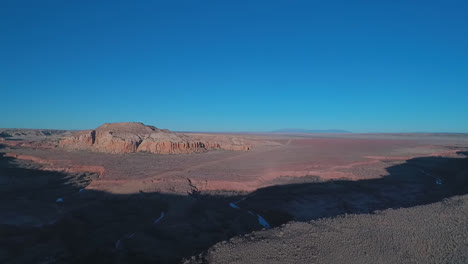 drone shot of river bed next to a mesa