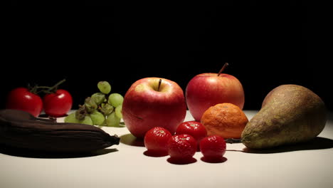 Variety-of-colorful-fruit-decomposing,-timelapse,-black-background