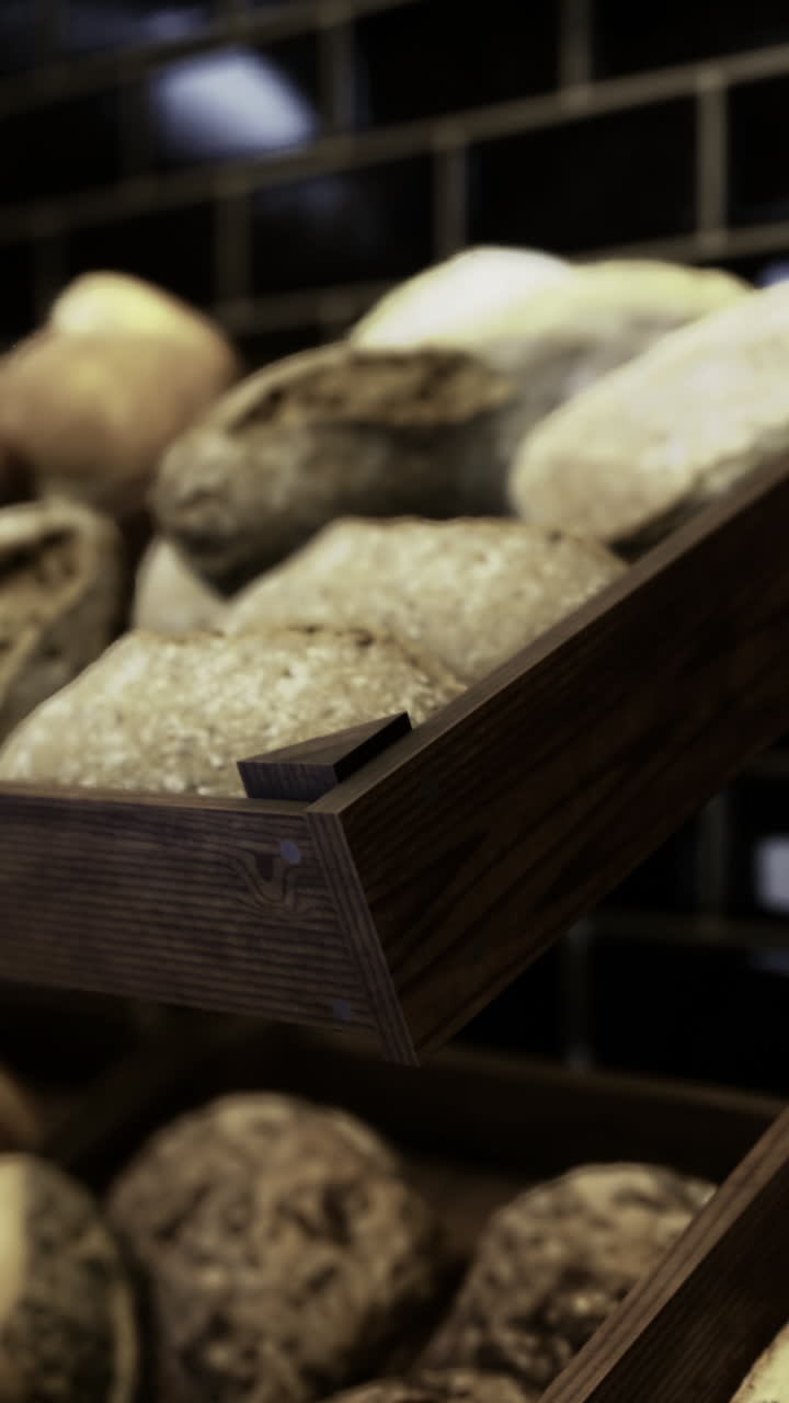 Freshly baked artisan breads displayed in wooden racks at a bakery