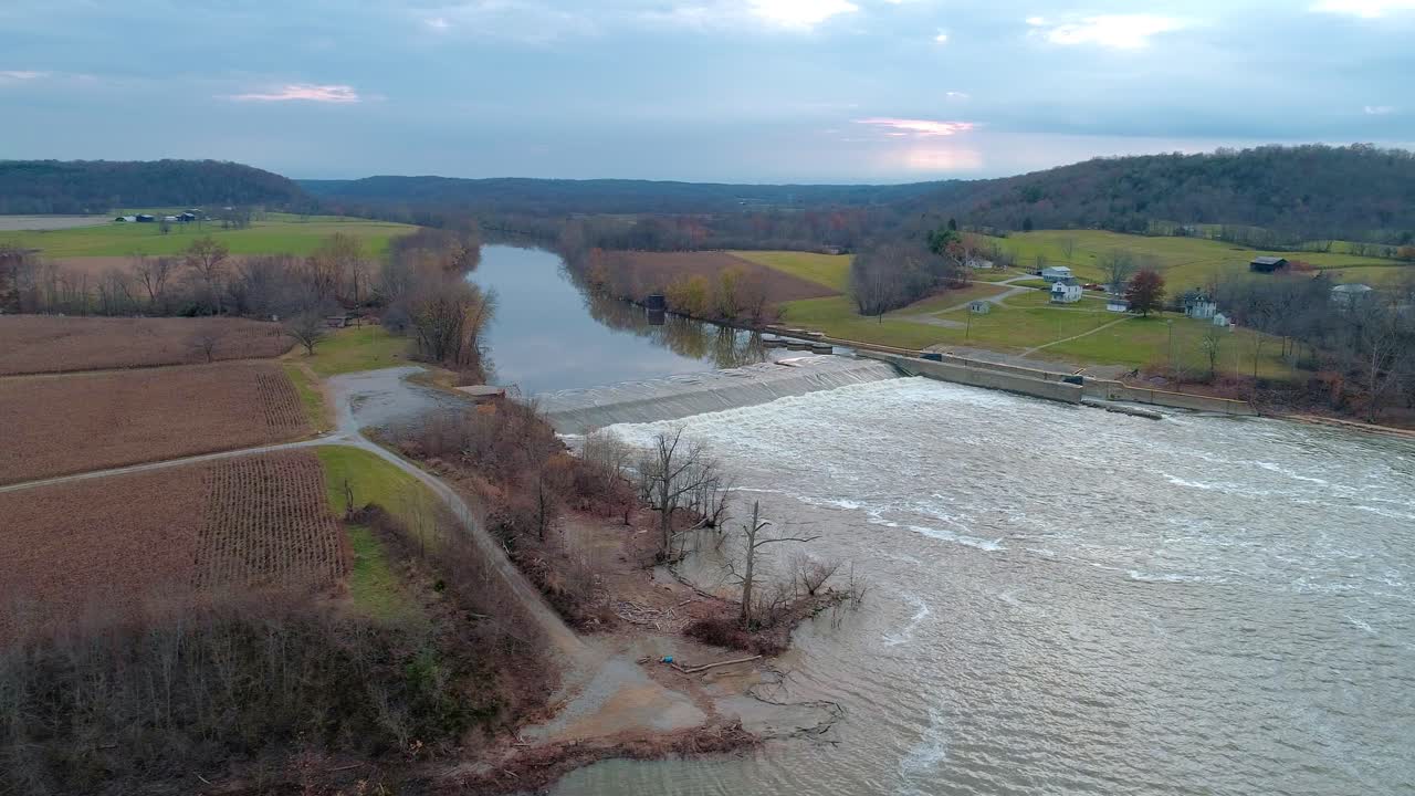 Aerial dolly shot to right of Kentucky river lock and dam number 3 in Monterey Kentucky in the fall at sunset