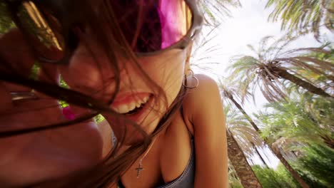 a young woman enjoying a sunny day among palm trees