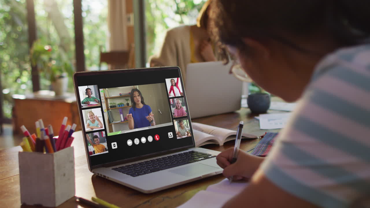 chica haciendo la tarea y teniendo una videoconferencia con el maestro y los compañeros de clase en la computadora portátil en casa