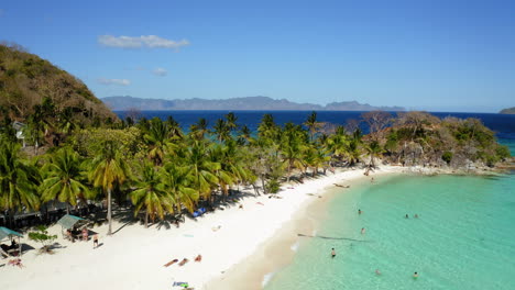 Aerial-view-of-Malcapuya-Beach-island-in-a-sunny-day,-Coron,-Palawan,-Philippines