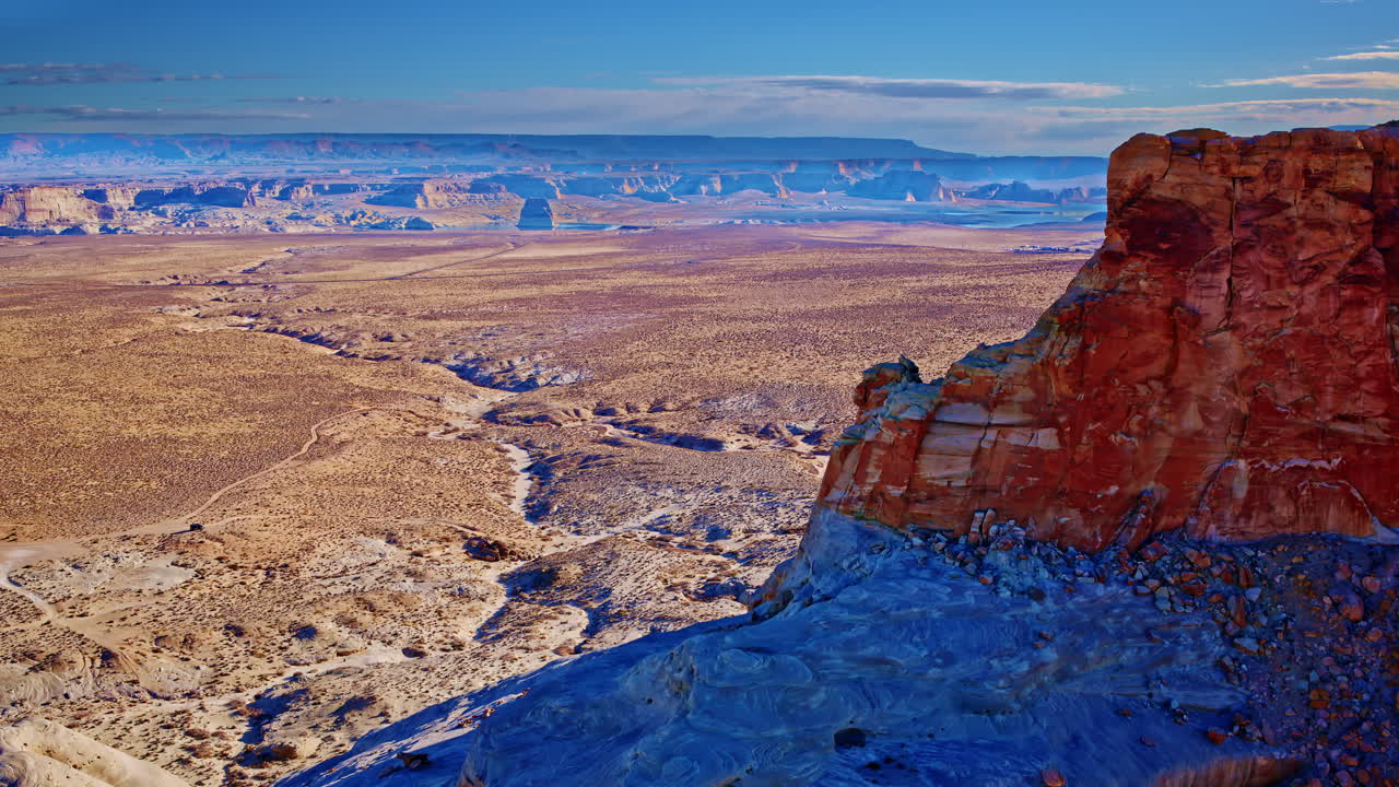The aerial perspective highlights Glen Canyon’s intricate rock formations and the shimmering expanse of Lake Powell.