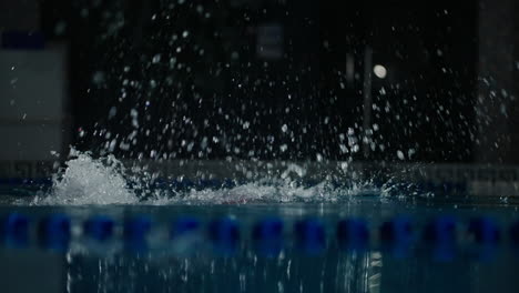 a swimmer in red cap training in a swimming pool