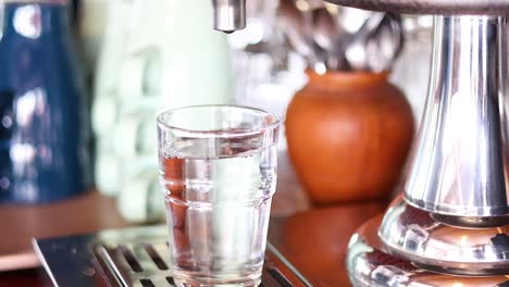 hand reaching for and lifting a glass of water