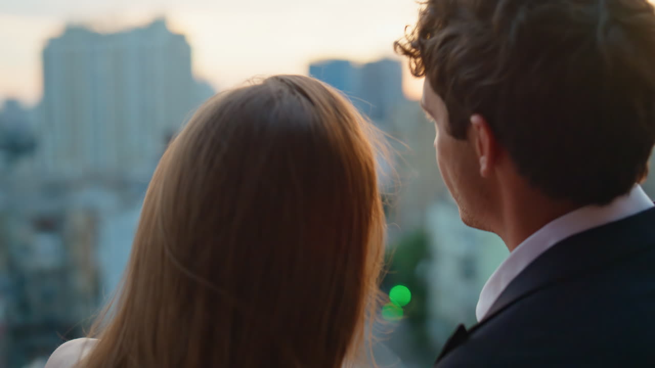 Intimate pair talking balcony sharing romantic conversation at evening closeup