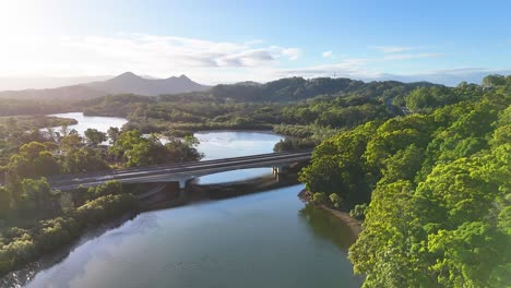 aerial view of river, bridge, and lush landscape