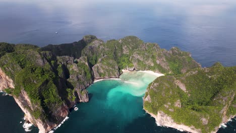 aerial drone video of phi phi leh with maya bay and pileh lagoon, krabi province, thailand. aerial top view of amazing tropical island with turquoise water and white beach, famous travel destination.