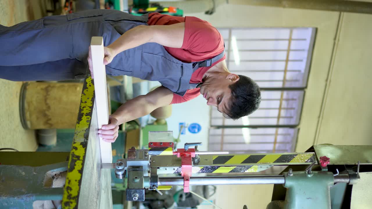 Man working with wood on a machine in a workshop