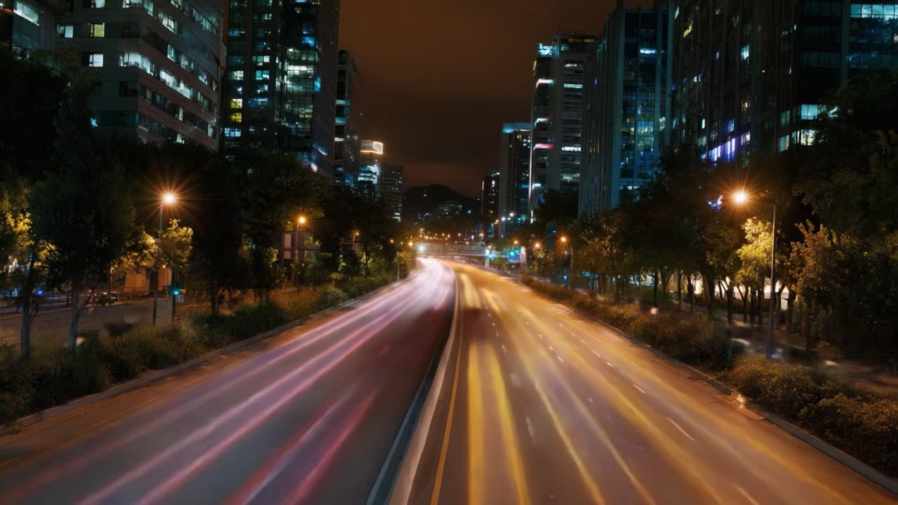 Dynamic Nightscape: Vibrant City Lights and Flowing Traffic on an Urban Highway Captured in Two Frames Showcasing Motion and Energy at Night