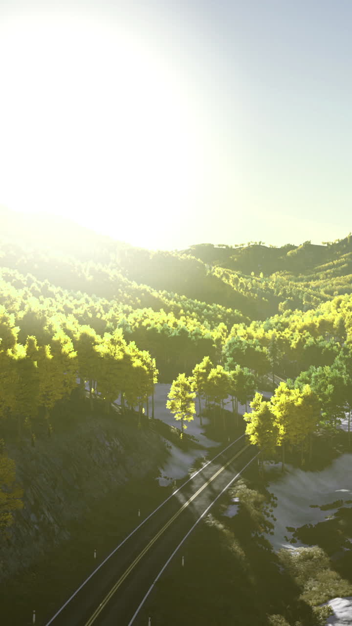Sunrise over lush green hills with railway tracks in a serene landscape