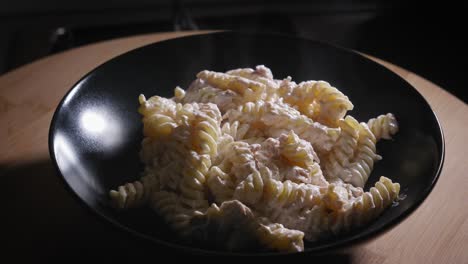 serving tuna pasta steaming hot tuna salad in a bowl - steady shot