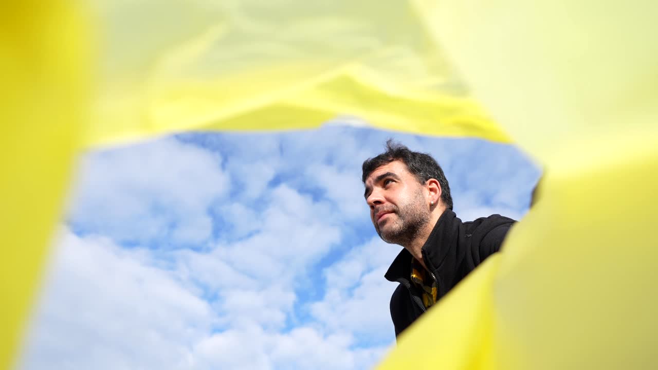 A man looking through a yellow hole in the sky