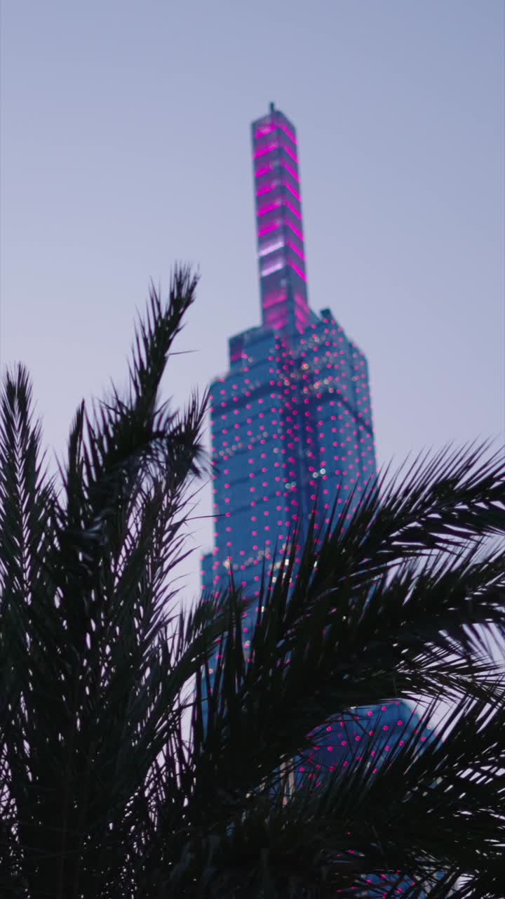 Modern skyscraper with pink lights at night