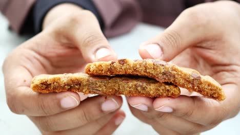 Women-breaking-sweet-cookies-close-up