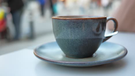 close-up of a blue coffee cup on a saucer