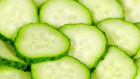 cucumber, sliced pieces of green cucumber stacked on a hill. circles of fresh cucumbers as food background