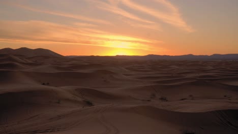 colorful sunset over the desert dunes in merzouga morocco