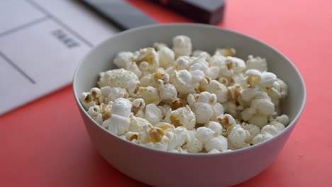 Movie-clapper-board-and-popcorn-on-table