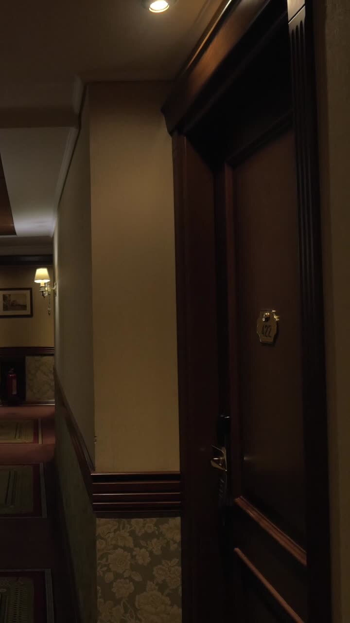 Empty Hotel Hallway with Classic Decor and Dim Lighting