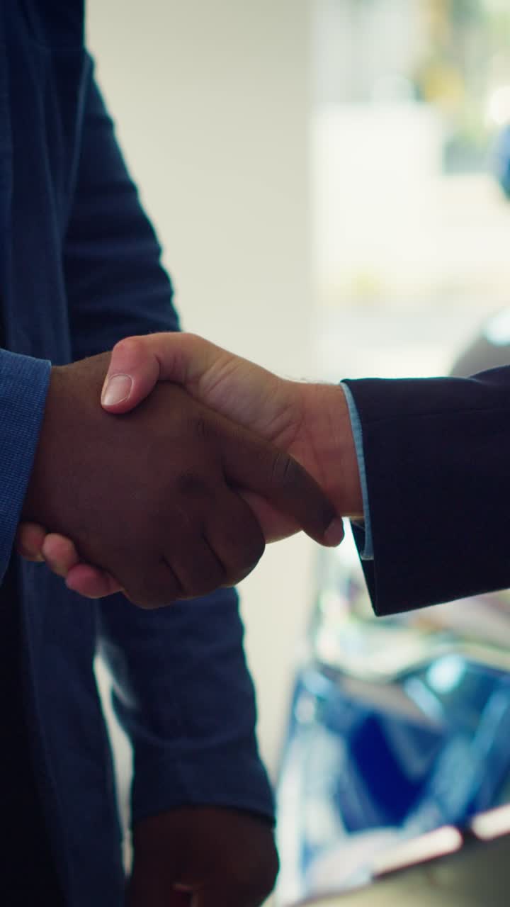 Customer and Salesperson Shaking Hands and Exchanging Car Keys