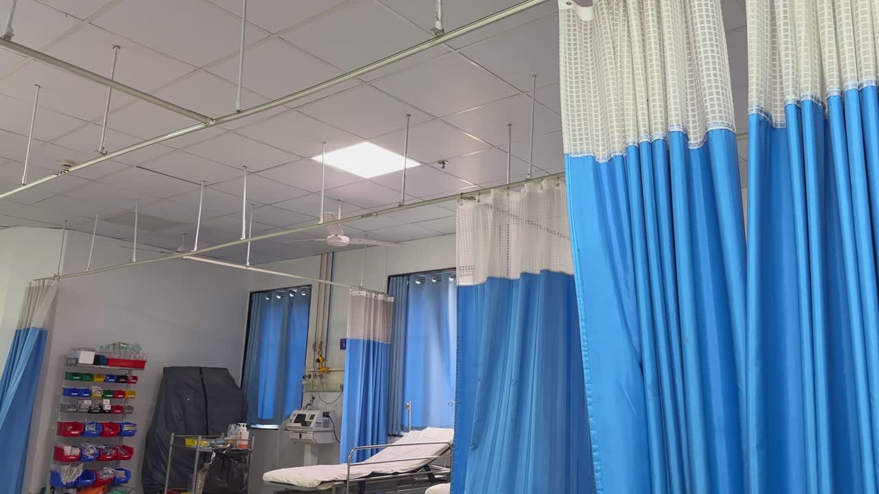Et førstepersonsperspektiv fra en moderne sykehusavdeling, med gardiner som blåser forsiktig i brisen.