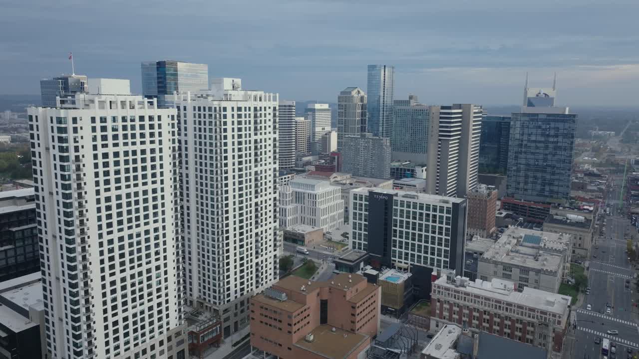 Aerial view of Nashville skyline with modern skyscrapers under cloudy sky