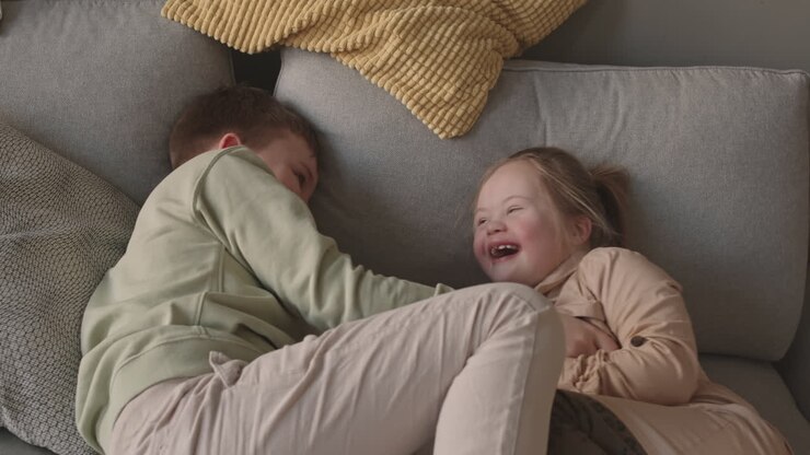 Siblings Playing on a Couch