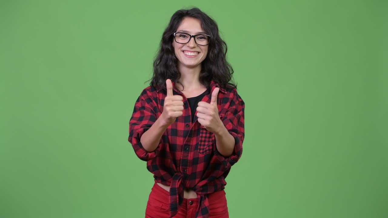 Young beautiful businesswoman giving thumbs up