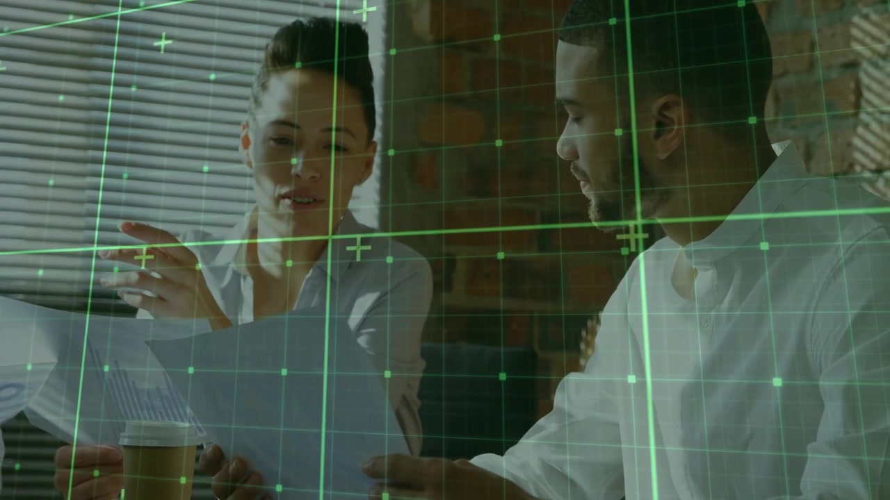 Left woman holding docs and cup, explaining to colleague, green grid overlaying charts for business