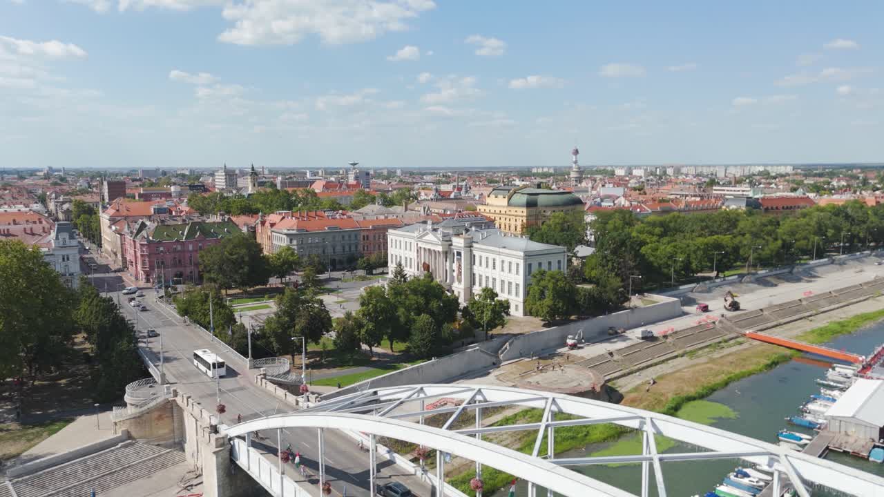 Majestic aerial perspective of Ferenc Móra Museum, showing the bridge below and surrounding city architecture