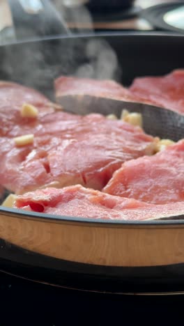 cooking fish with garlic in a pan