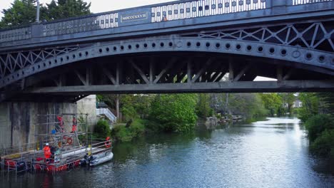 maintenance work takes place on the underside of a bridge