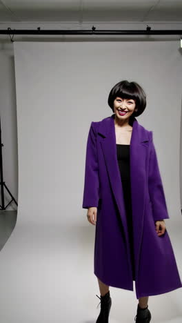 playful and expressive studio portraits of a woman in a purple jacket